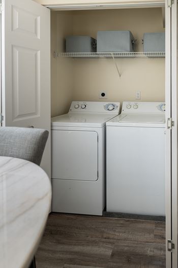 A small laundry room with a washer and dryer.